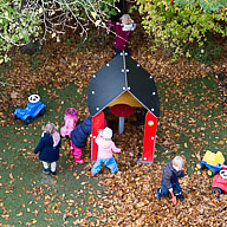 Children play in the garden of Minihaus München in Obermenzing